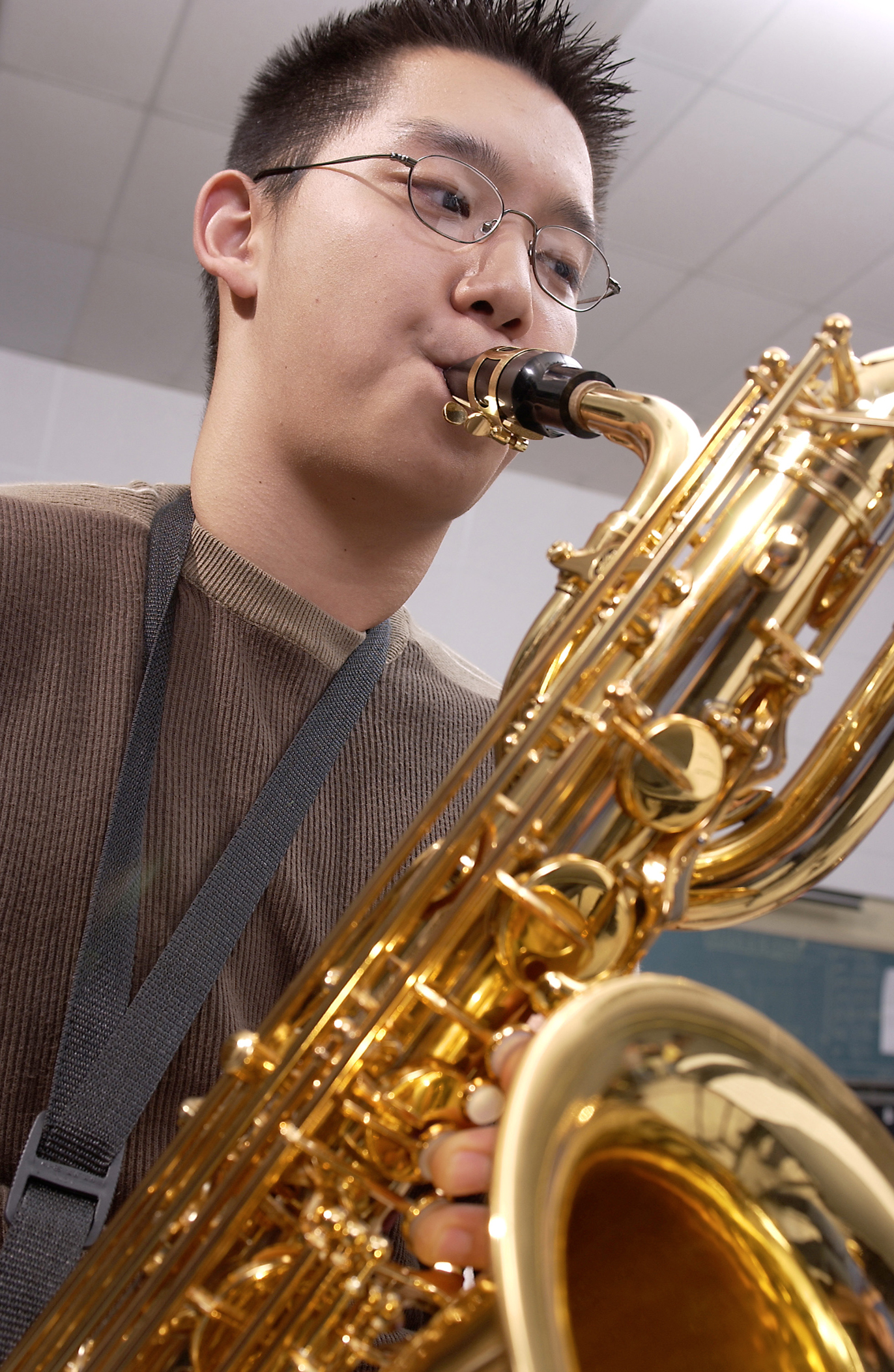 Boy plaing yamaha baritone saxophone