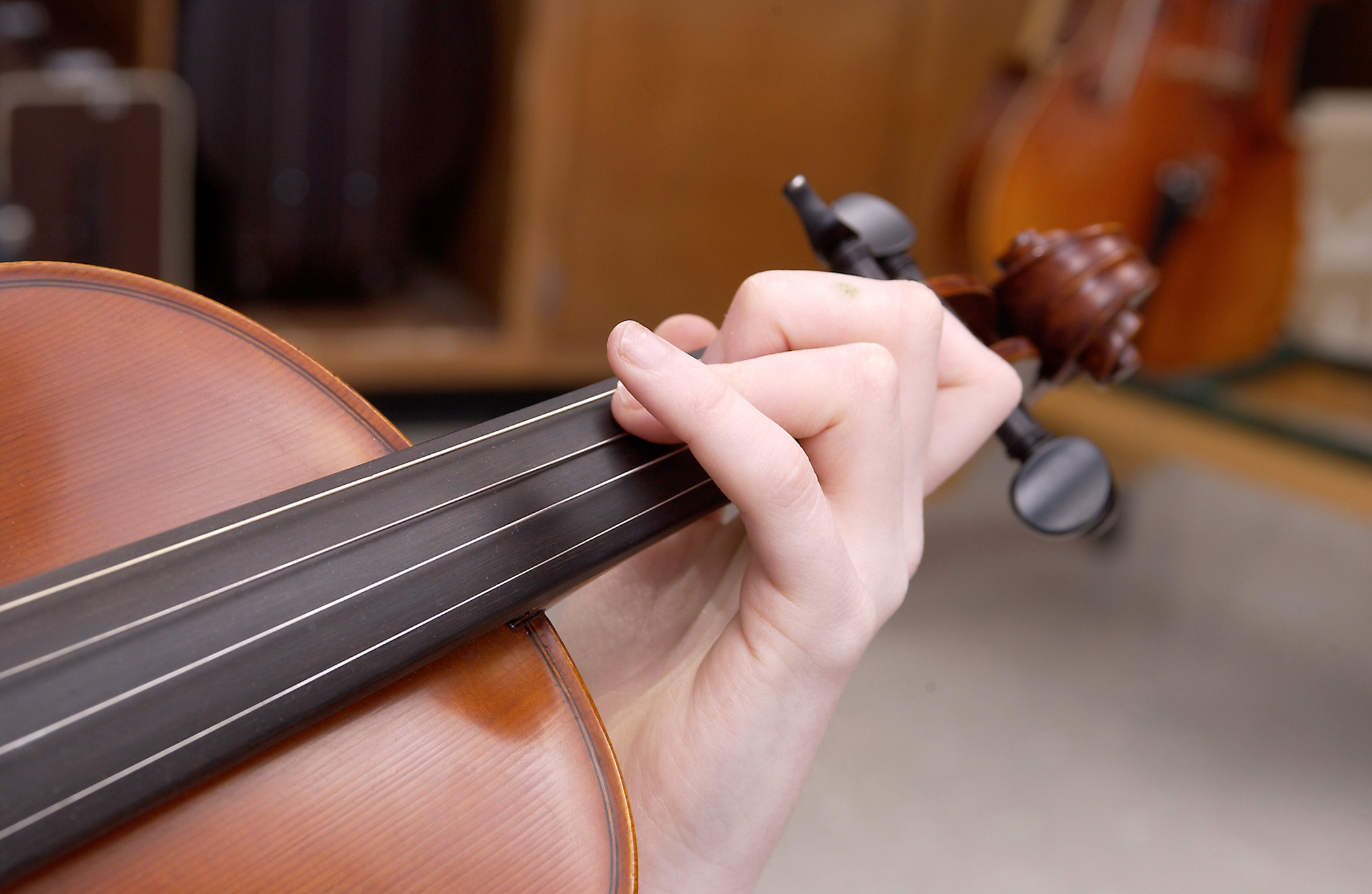 Violin with hand playing strings